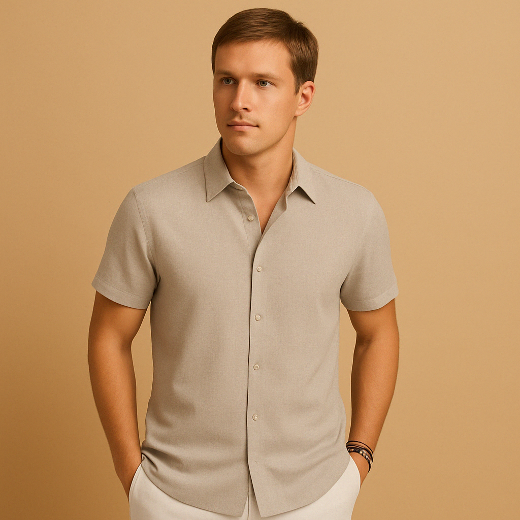 Man wearing a beige short-sleeve shirt against a beige background