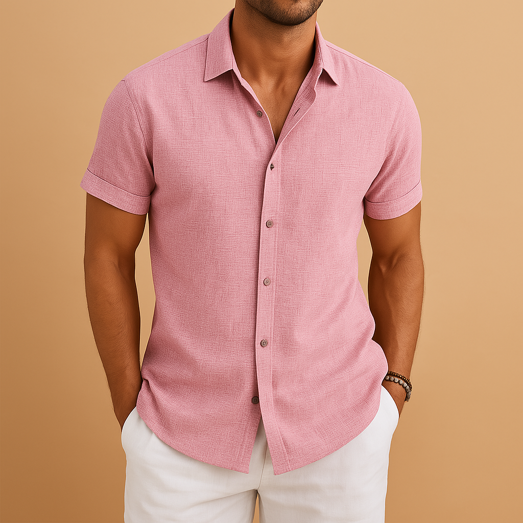 Man wearing a pink short-sleeve shirt against a beige background